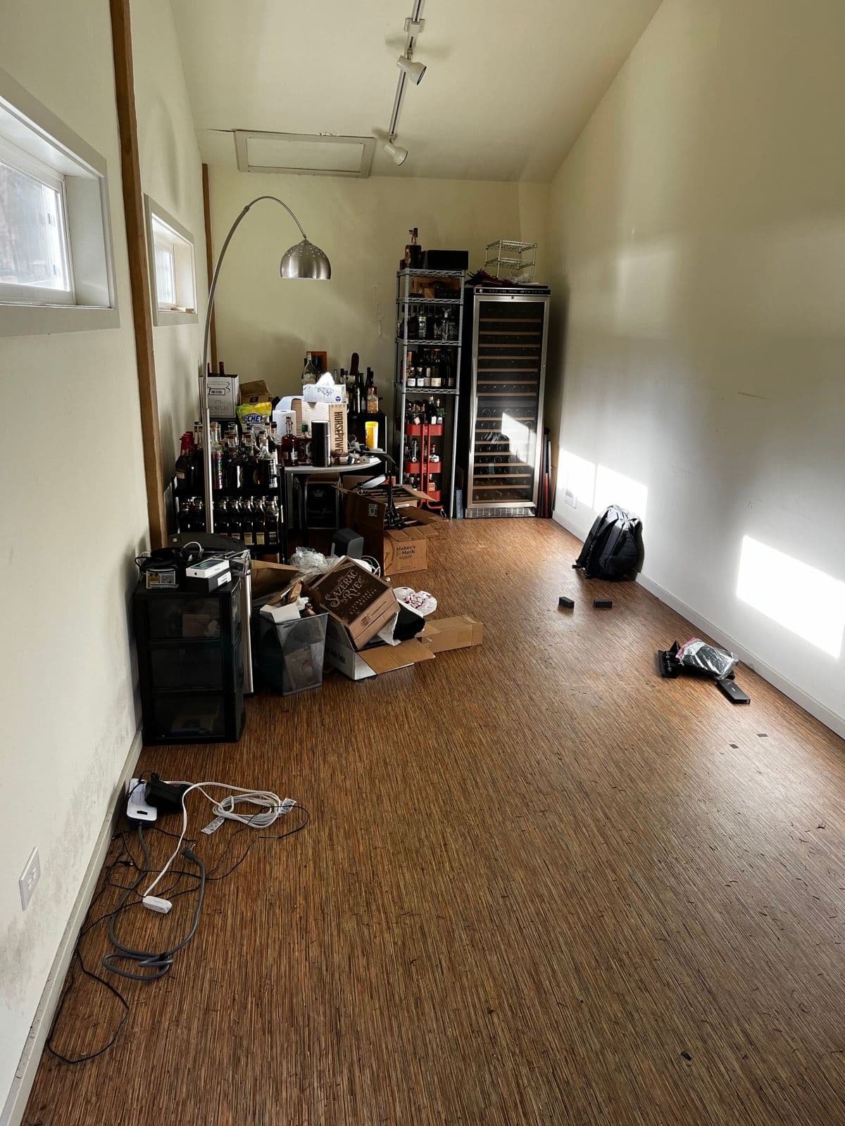 The room from the other angle, wine fridges overflowing in the corner