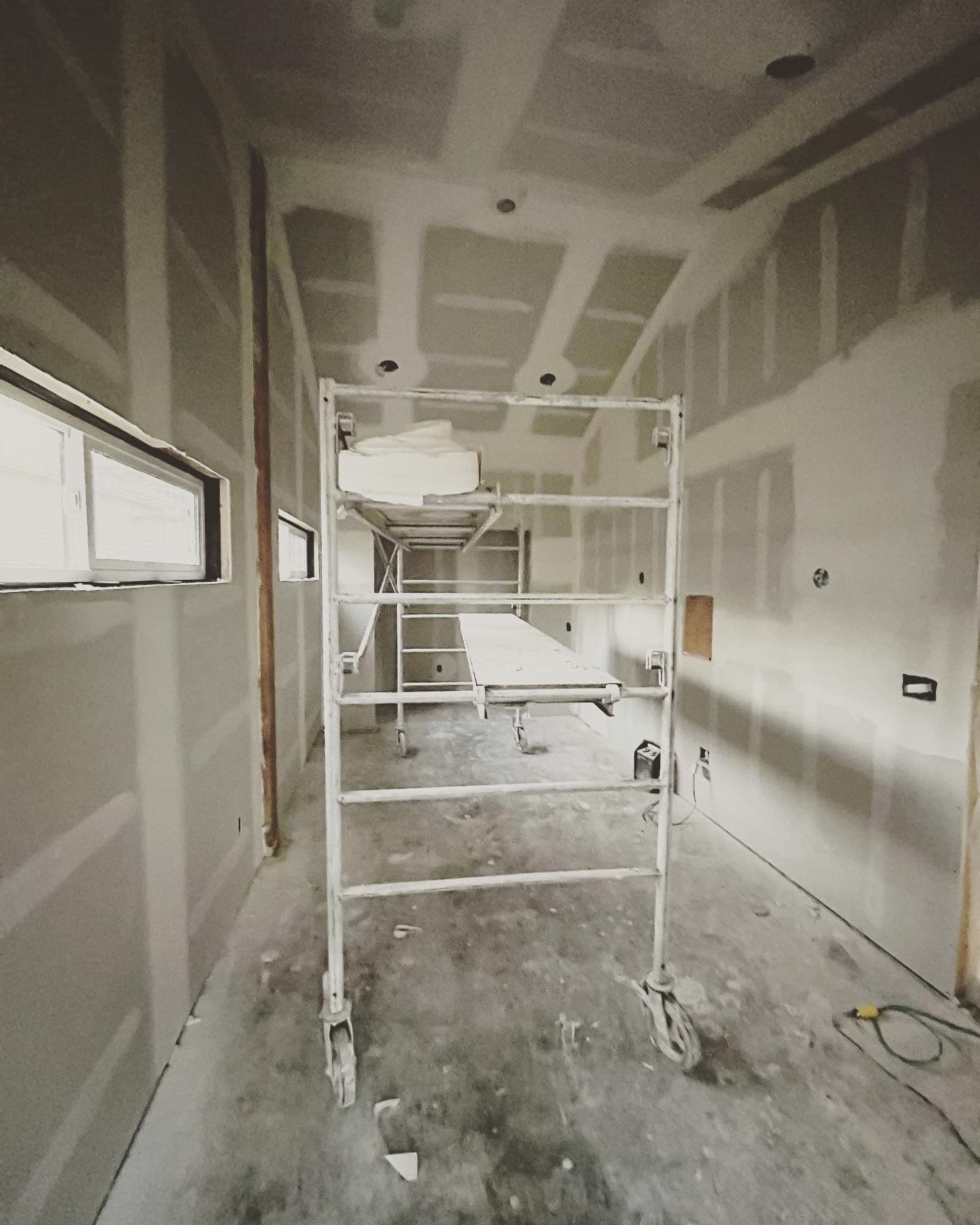 Scaffolding set up for drywall installation on the vaulted ceiling