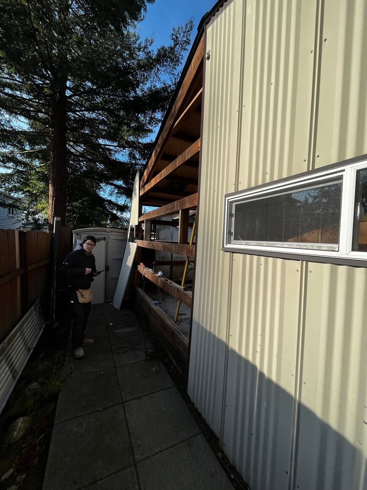New siding and metal roof being installed on the exterior
