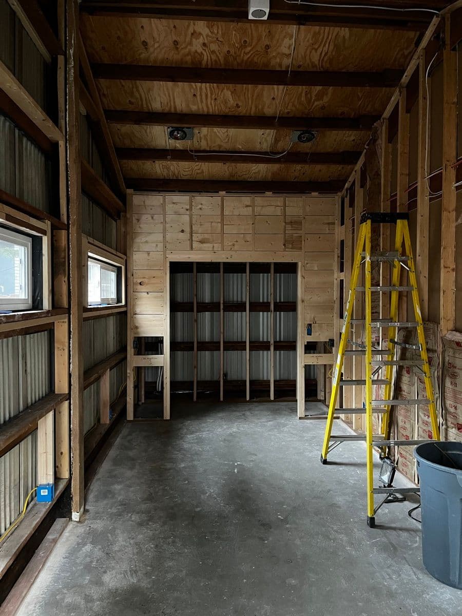Wine cellar framing with ladder — the room within a room taking shape