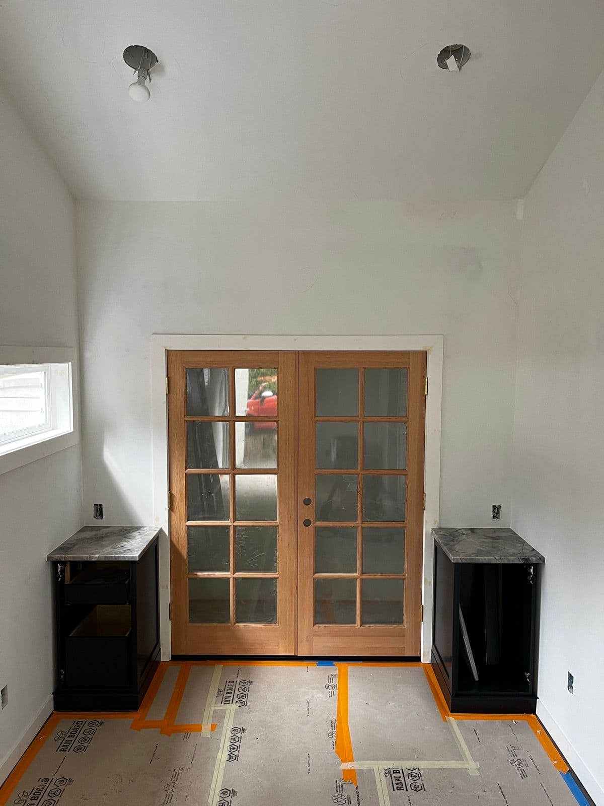 French doors installed with black cabinets on either side