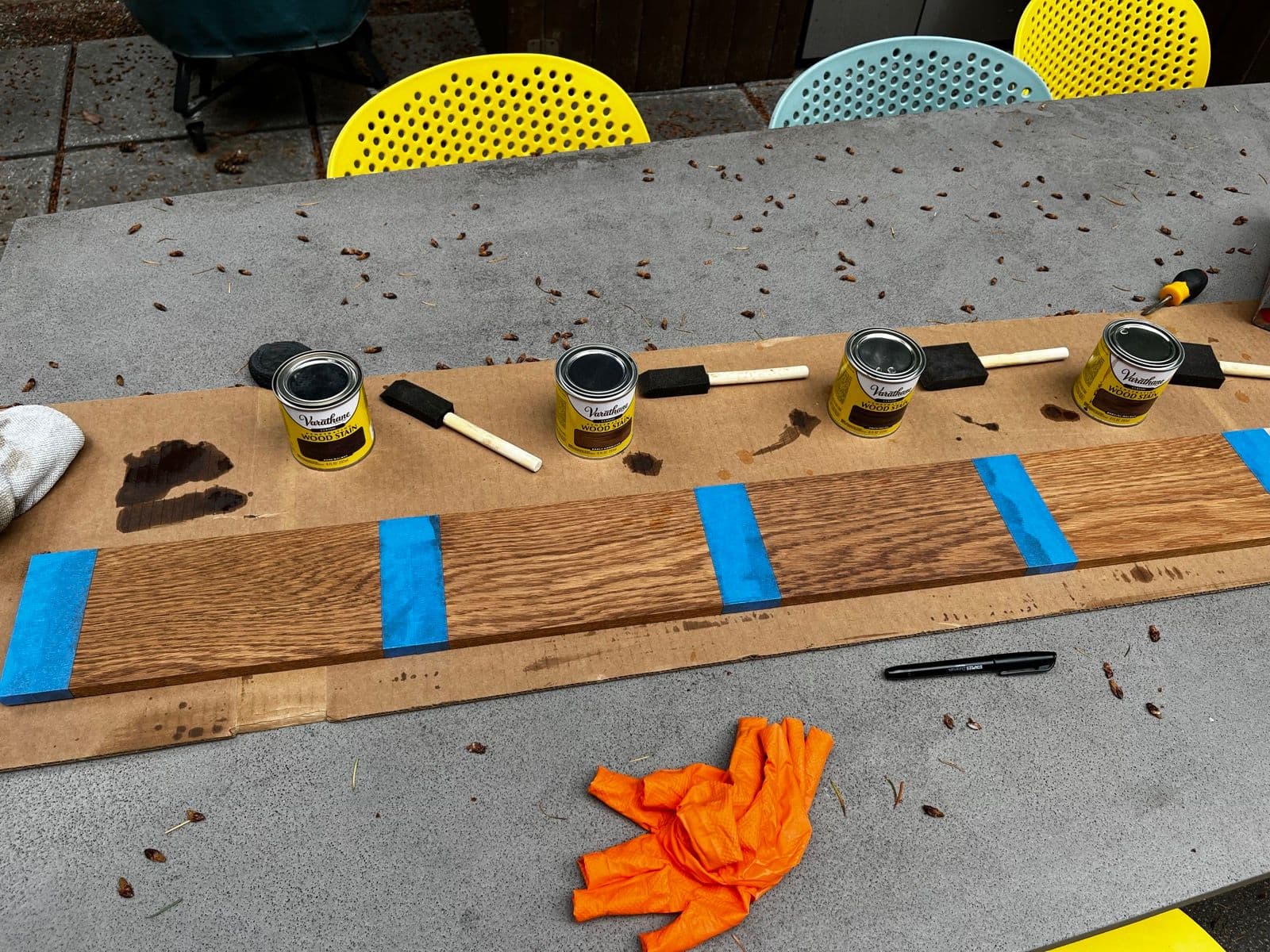 Testing stain samples on the wood for the whiskey shelves